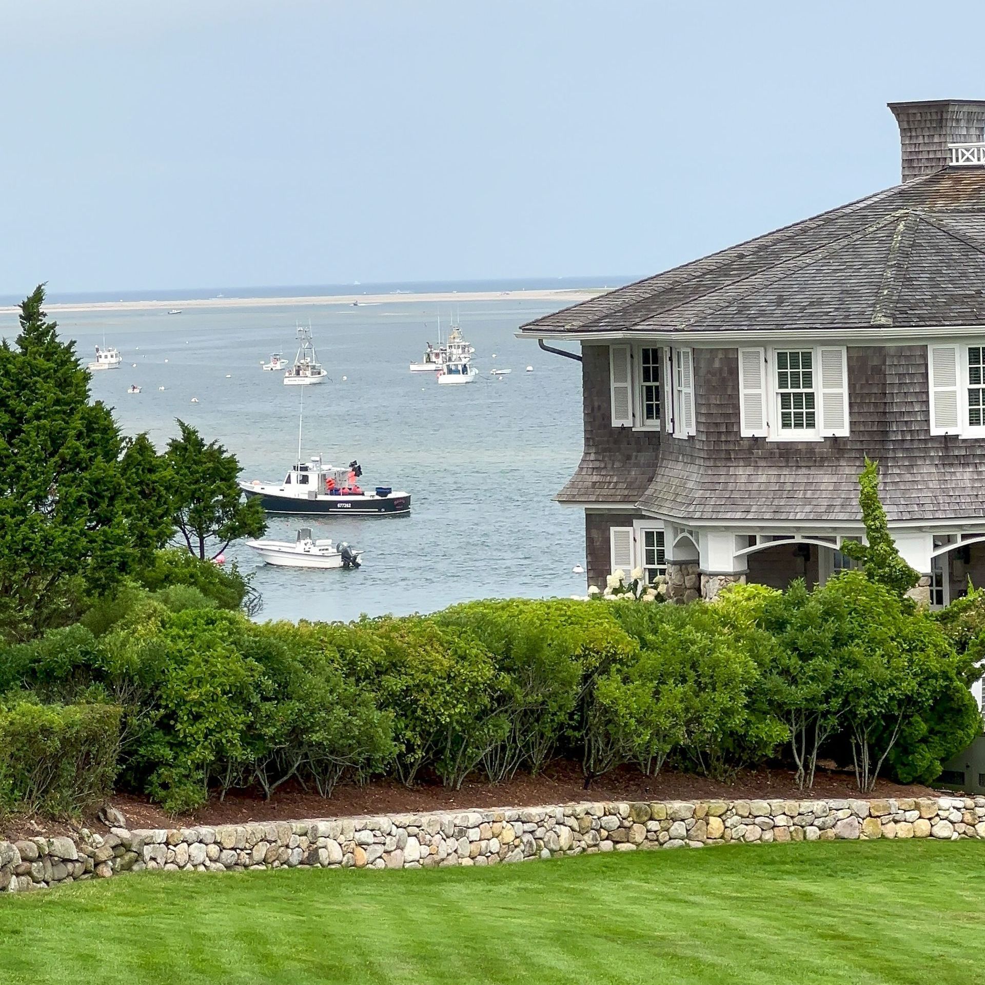 A house overlooking a body of water with boats in it