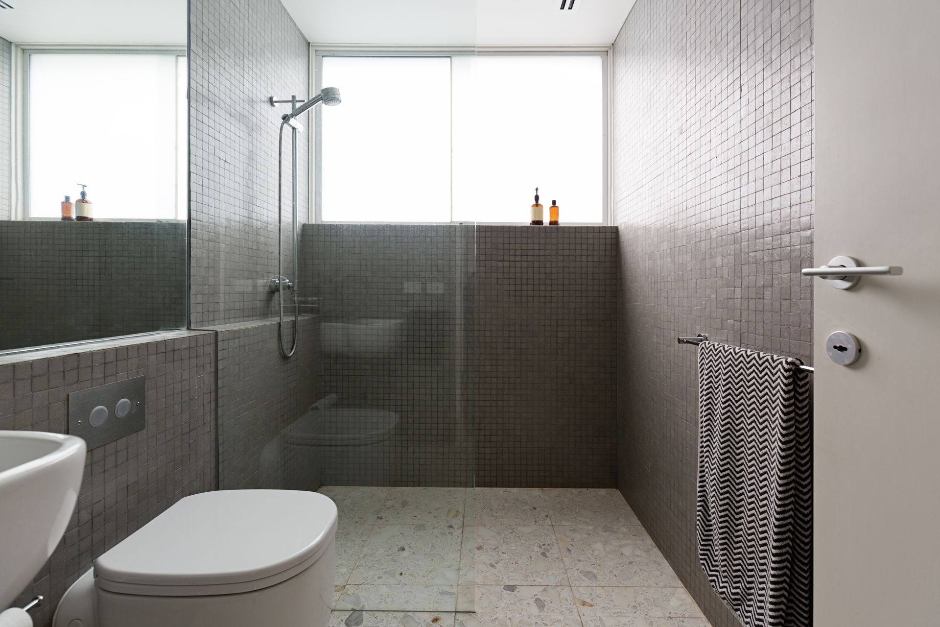 Modern bathroom with elegant frameless shower doors and tiled walls