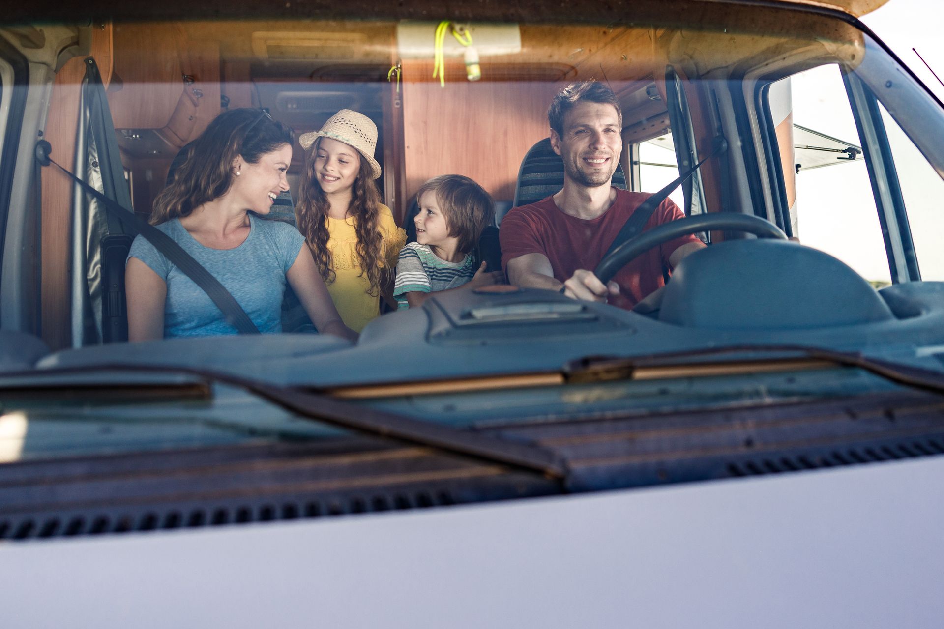 A happy family enjoys their RV, with clear glass windows from Atlantic Glass & Mirror, specialists i