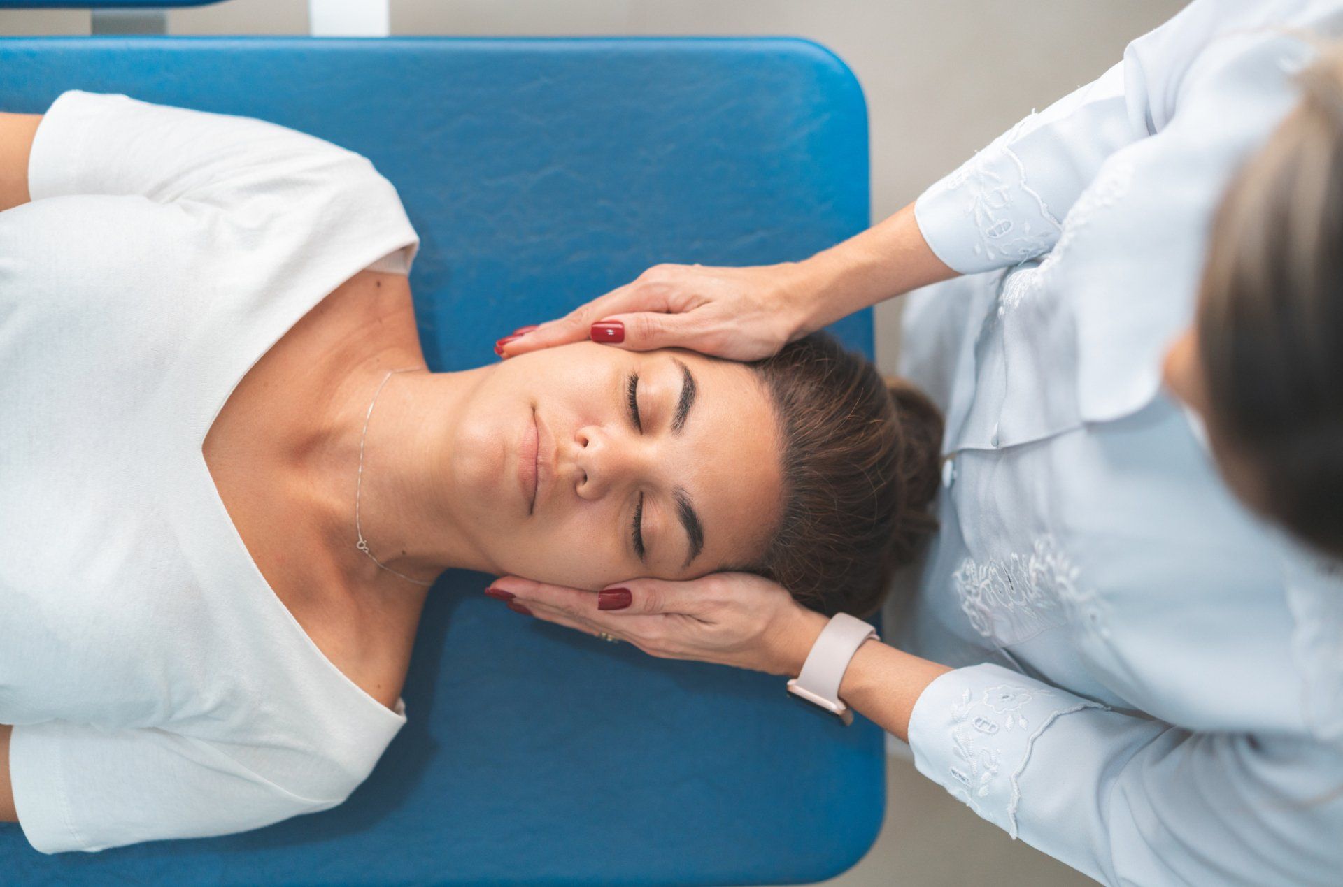 Woman Giving Head Massage — Honolulu, HI — Randy R Collins, D.C., Inc Woman Giving Head Massage — Honolulu, HI — Randy R Collins, D.C., Inc