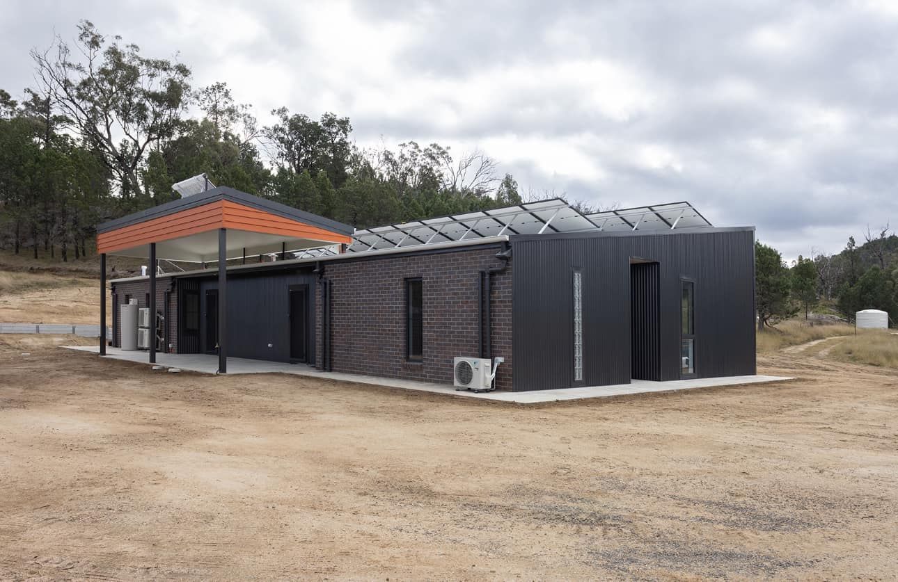 Newly built grey home with dirt in front of it — L & K Electrical & Air Conditioning in Tamworth, NSW