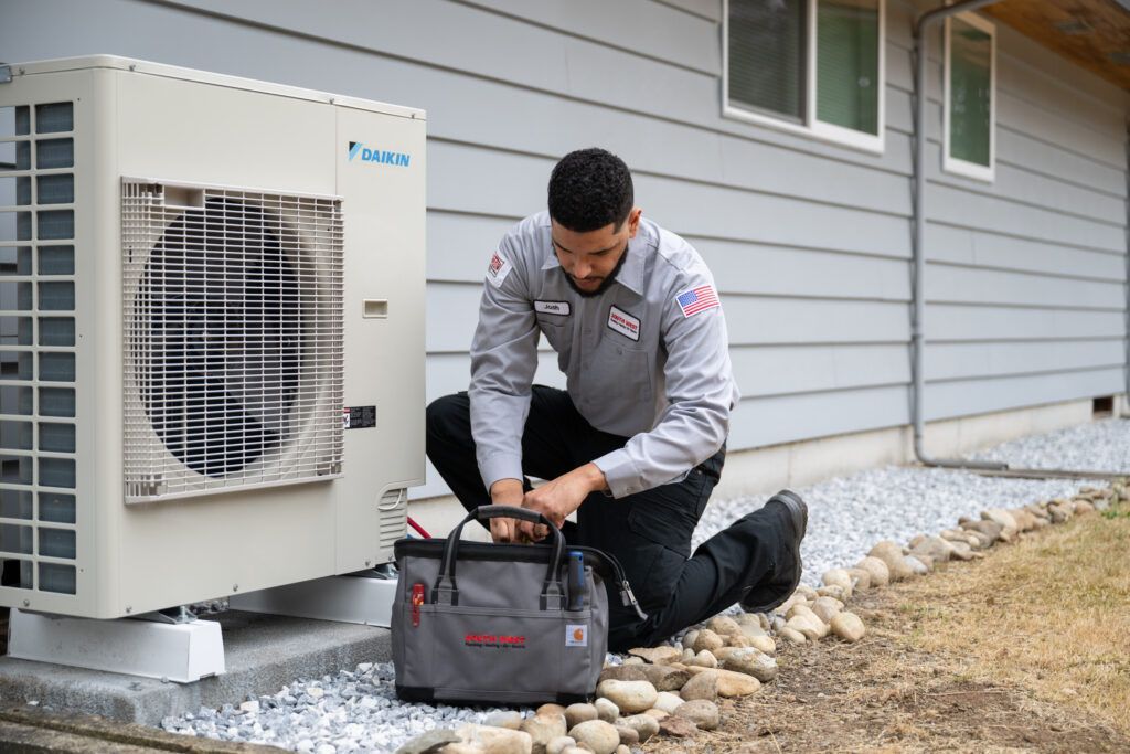 A White Air Conditioner is Mounted on a Wall — L & K Electrical & Air Conditioning in Barraba, NSW