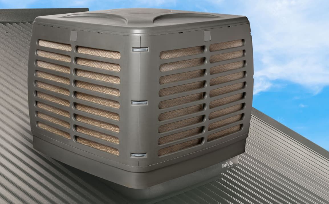 A Large Air Conditioner Is Mounted On The Roof Of A Building — L & K Electrical & Air Conditioning in Tamworth, NSW