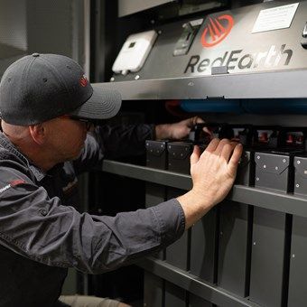 A technician replacing solar batteries — L & K Electrical & Air Conditioning in Tamworth, NSW