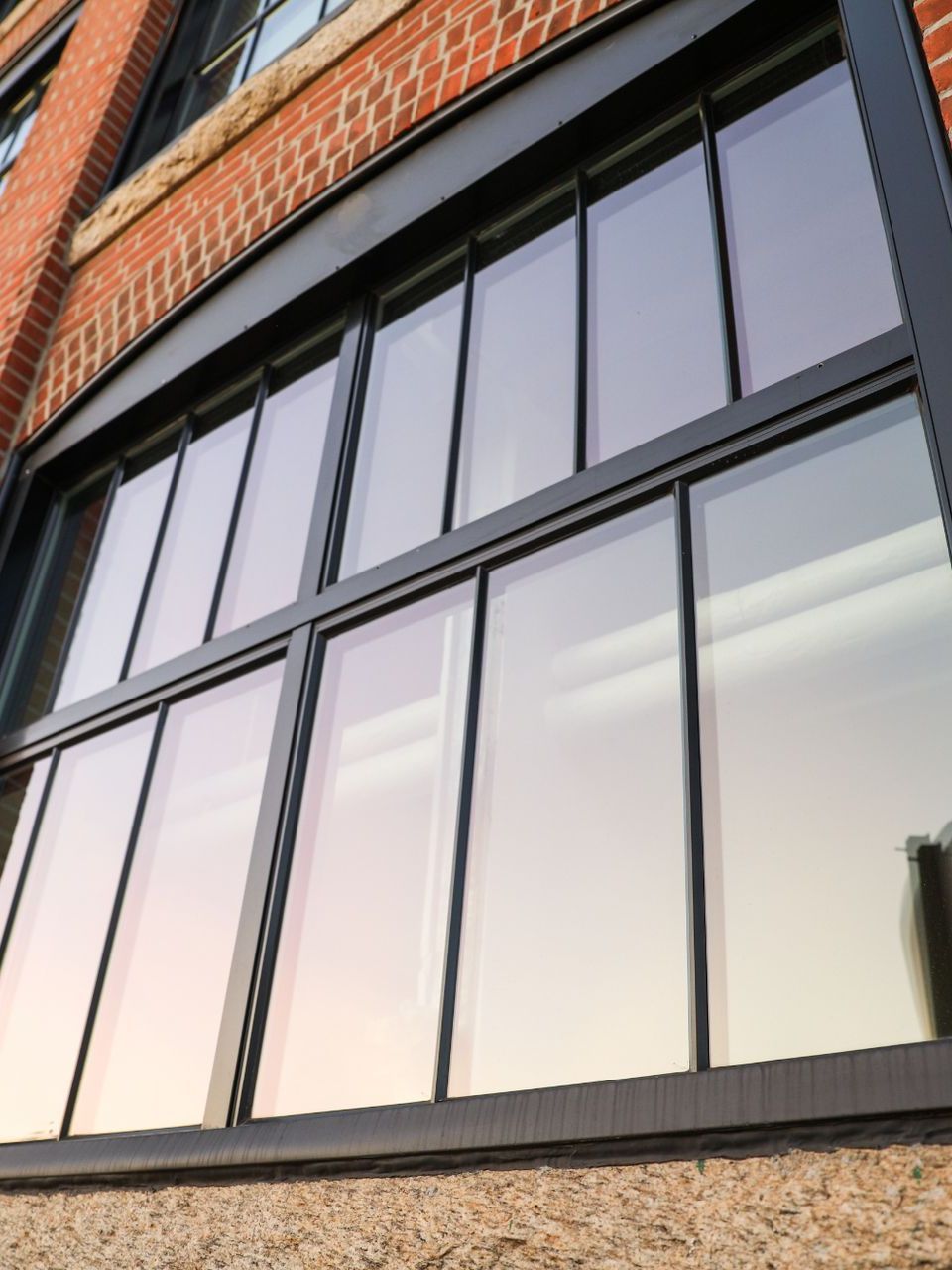 A large window on the side of a brick building