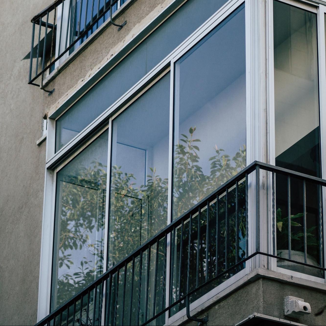 A balcony with sliding glass doors and a metal railing