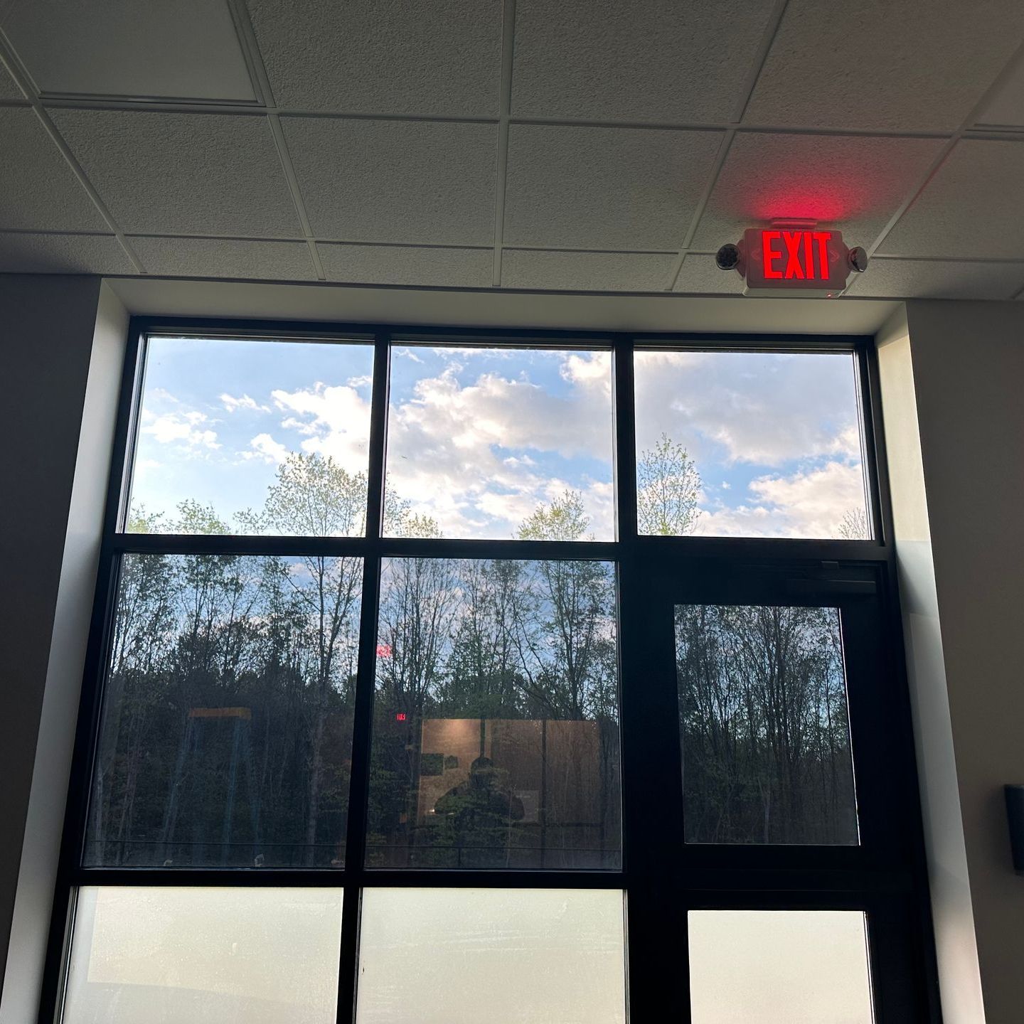 A window with a red exit sign above it