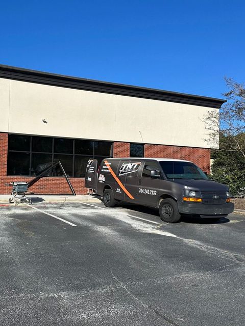 A van is parked in front of a building.