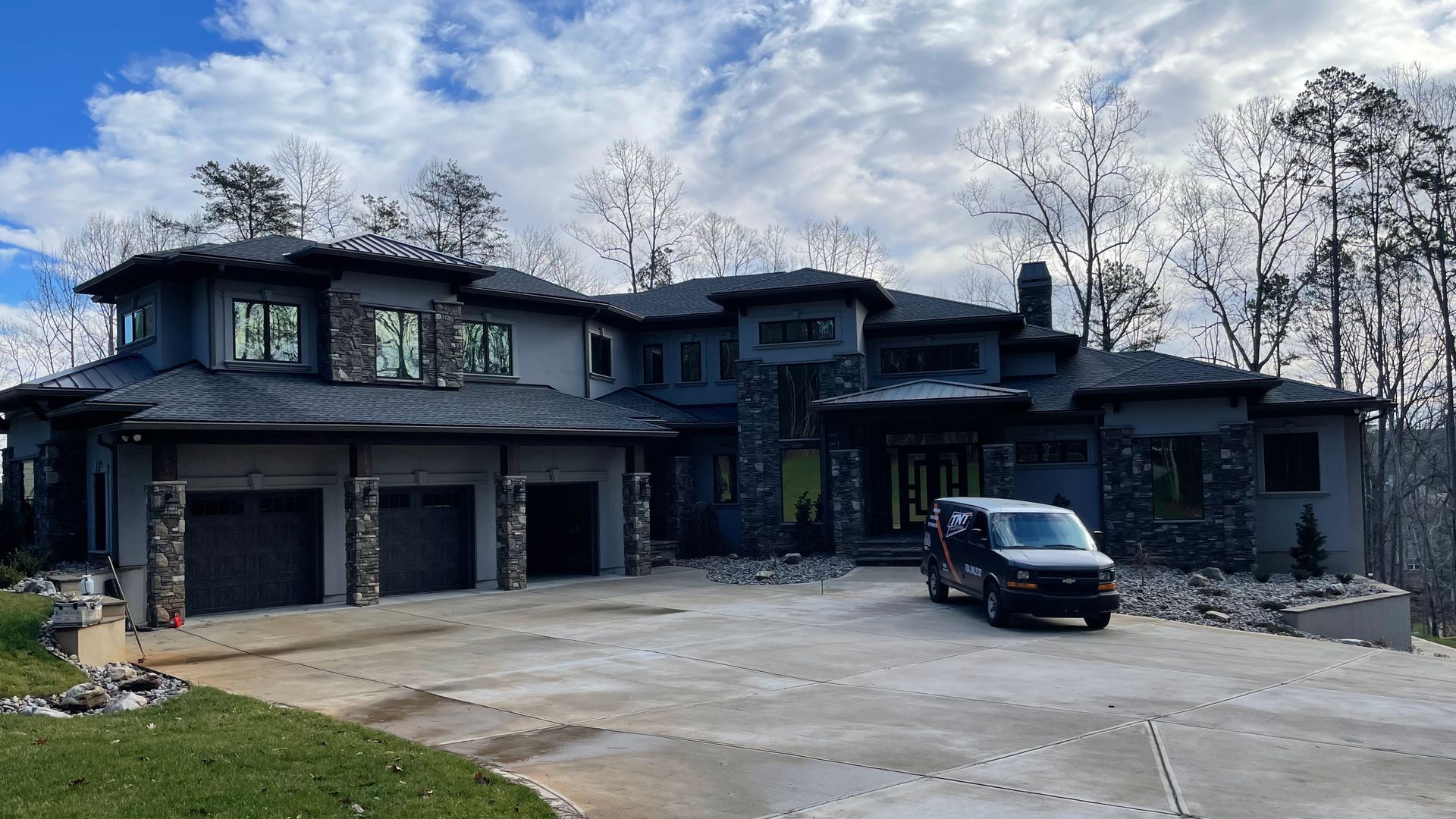 A large house with a van parked in front of it.