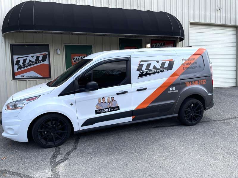 A white and gray cargo van branded with the