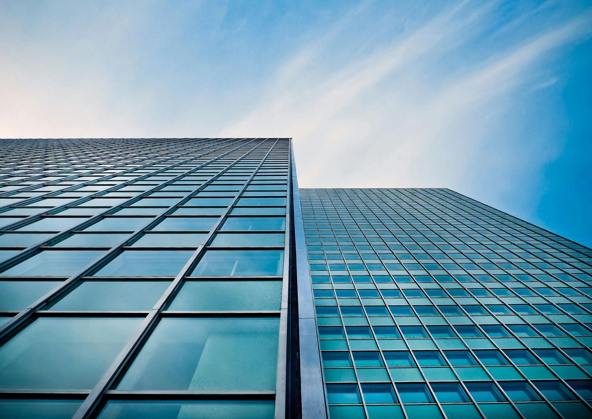 Looking up at a tall building with a blue sky in the background