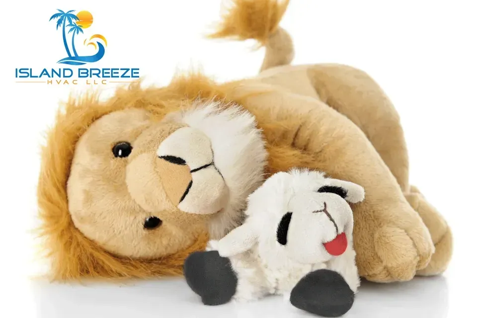 A stuffed lion and a stuffed sheep are laying next to each other