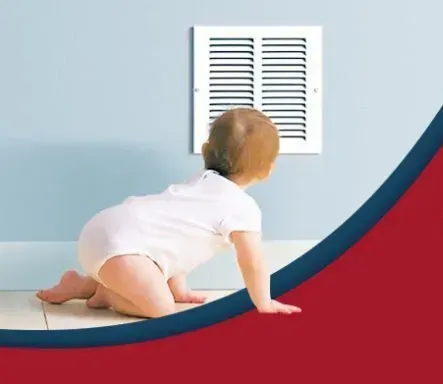 A baby is crawling on the floor in front of a window