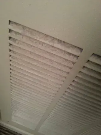 A close up of an air vent on a wall.