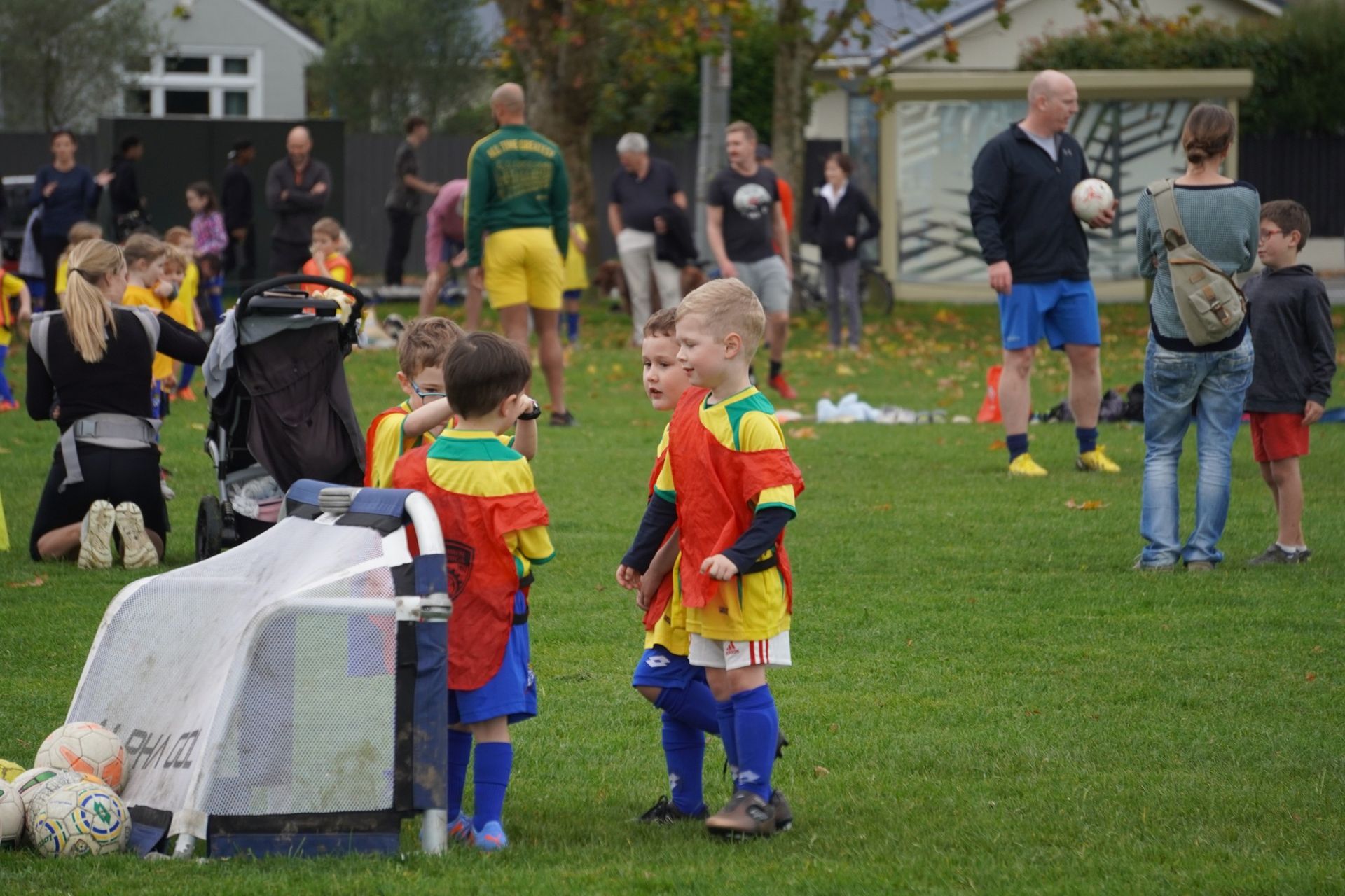 A group of children are playing soccer on a field.