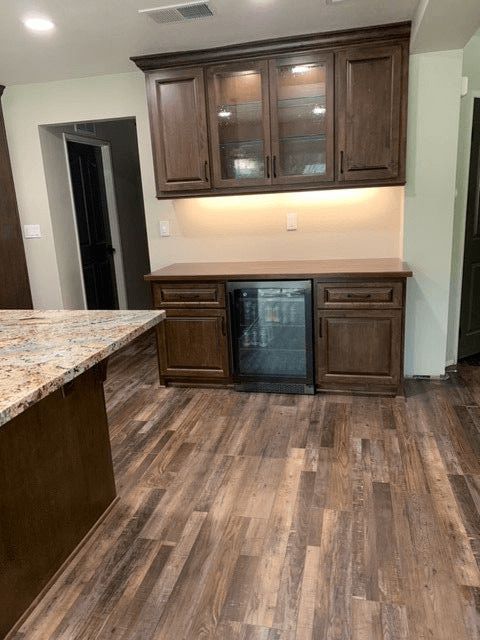 A kitchen with wooden cabinets and a refrigerator