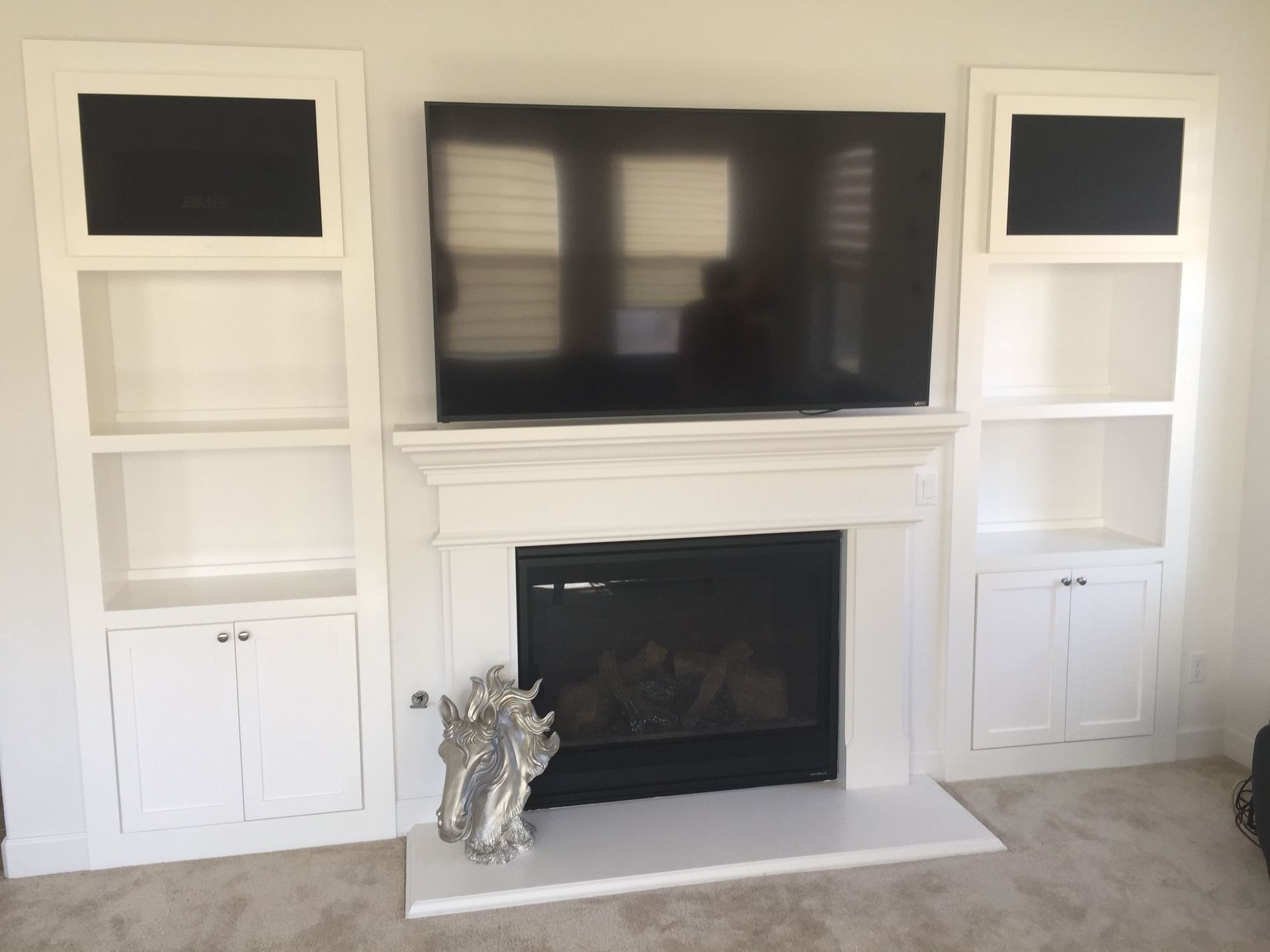 A living room with a fireplace and a flat screen tv
