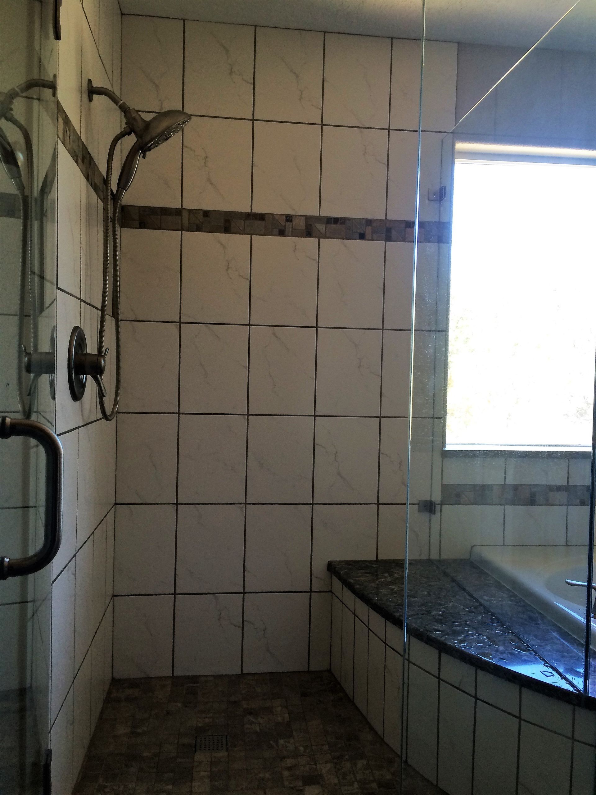 A bathroom with a walk in shower and a bathtub