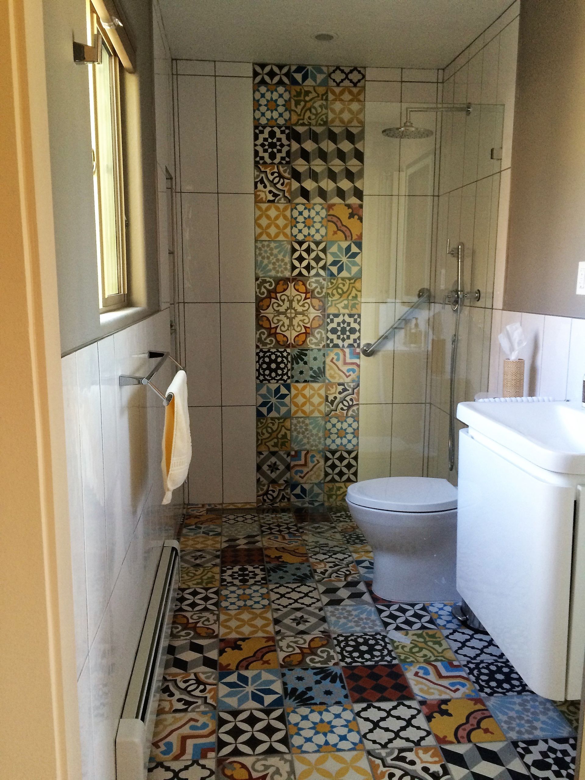 A bathroom with a toilet , sink , and shower.