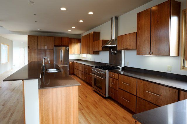 A kitchen with wooden cabinets and stainless steel appliances
