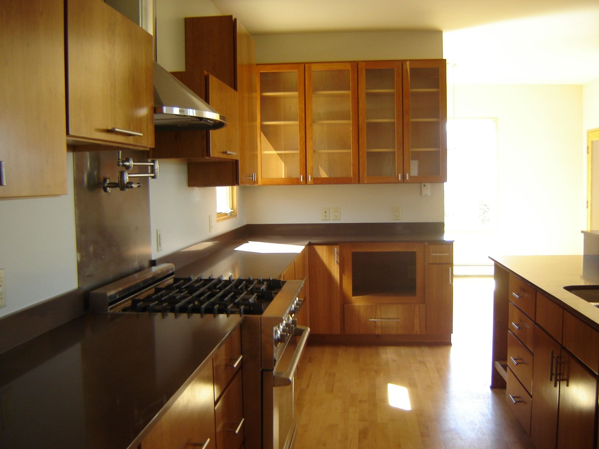 A kitchen with wooden cabinets and a stove top oven