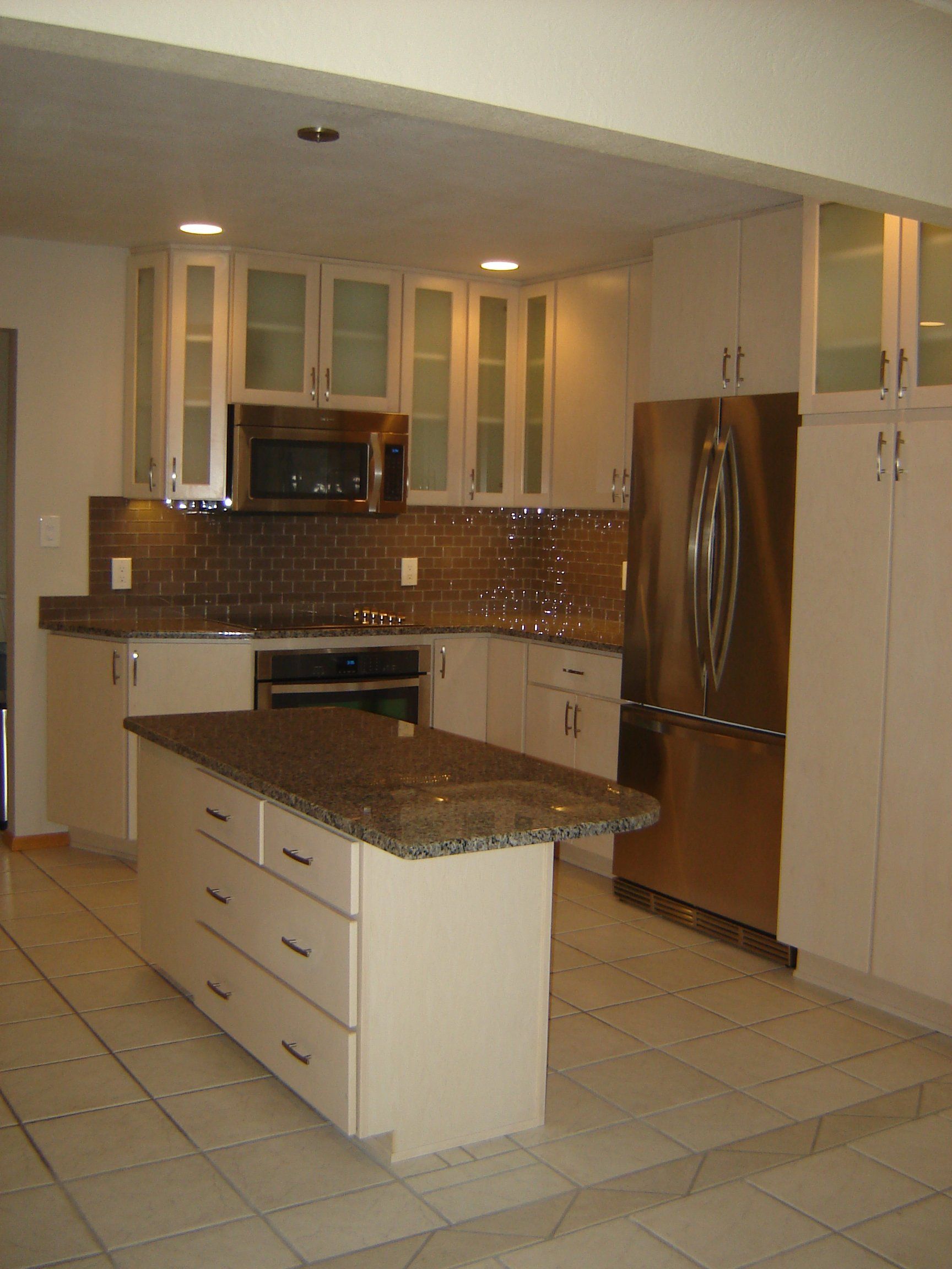 A kitchen with stainless steel appliances and granite counter tops