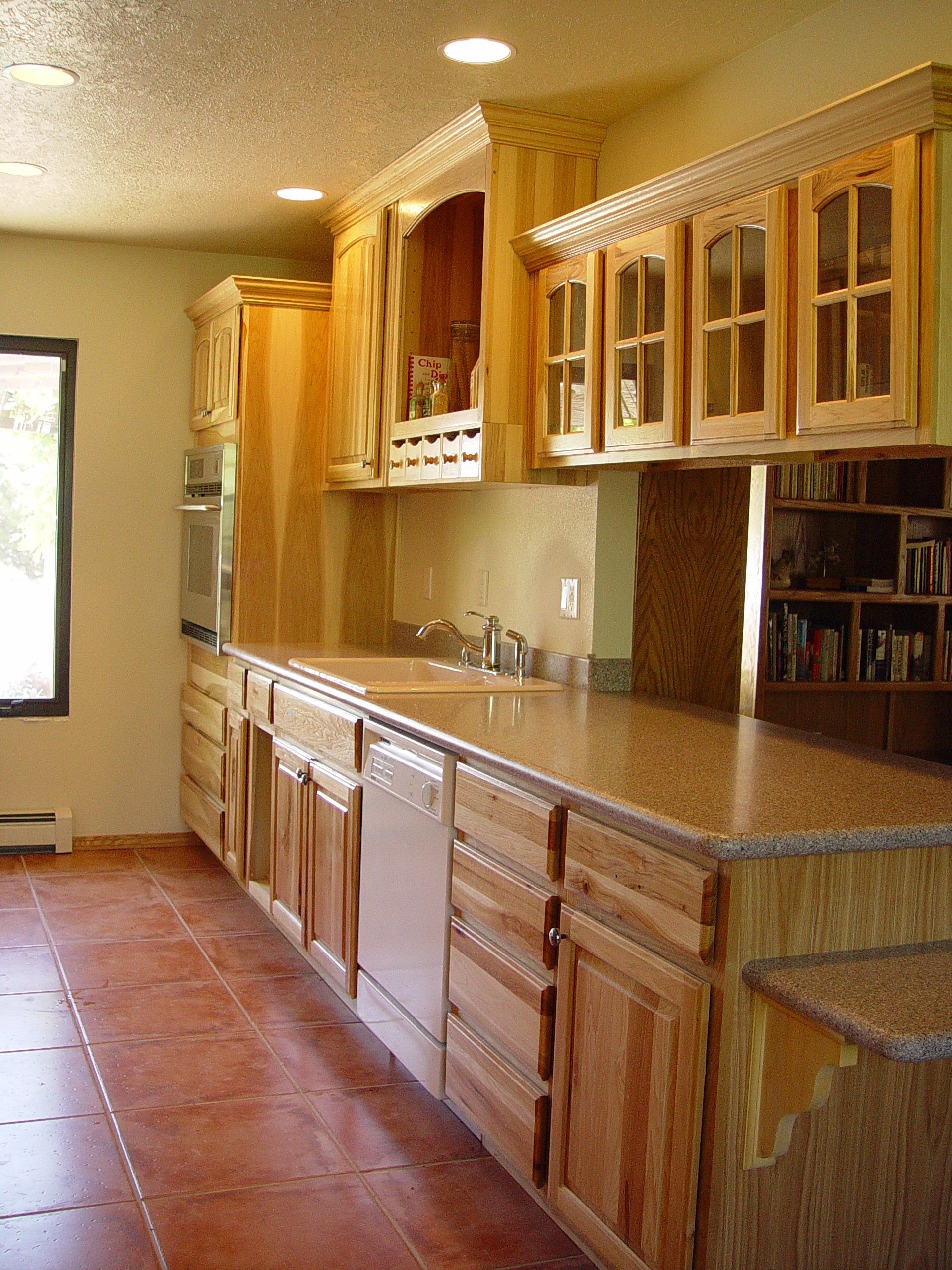 A kitchen with wooden cabinets and granite counter tops