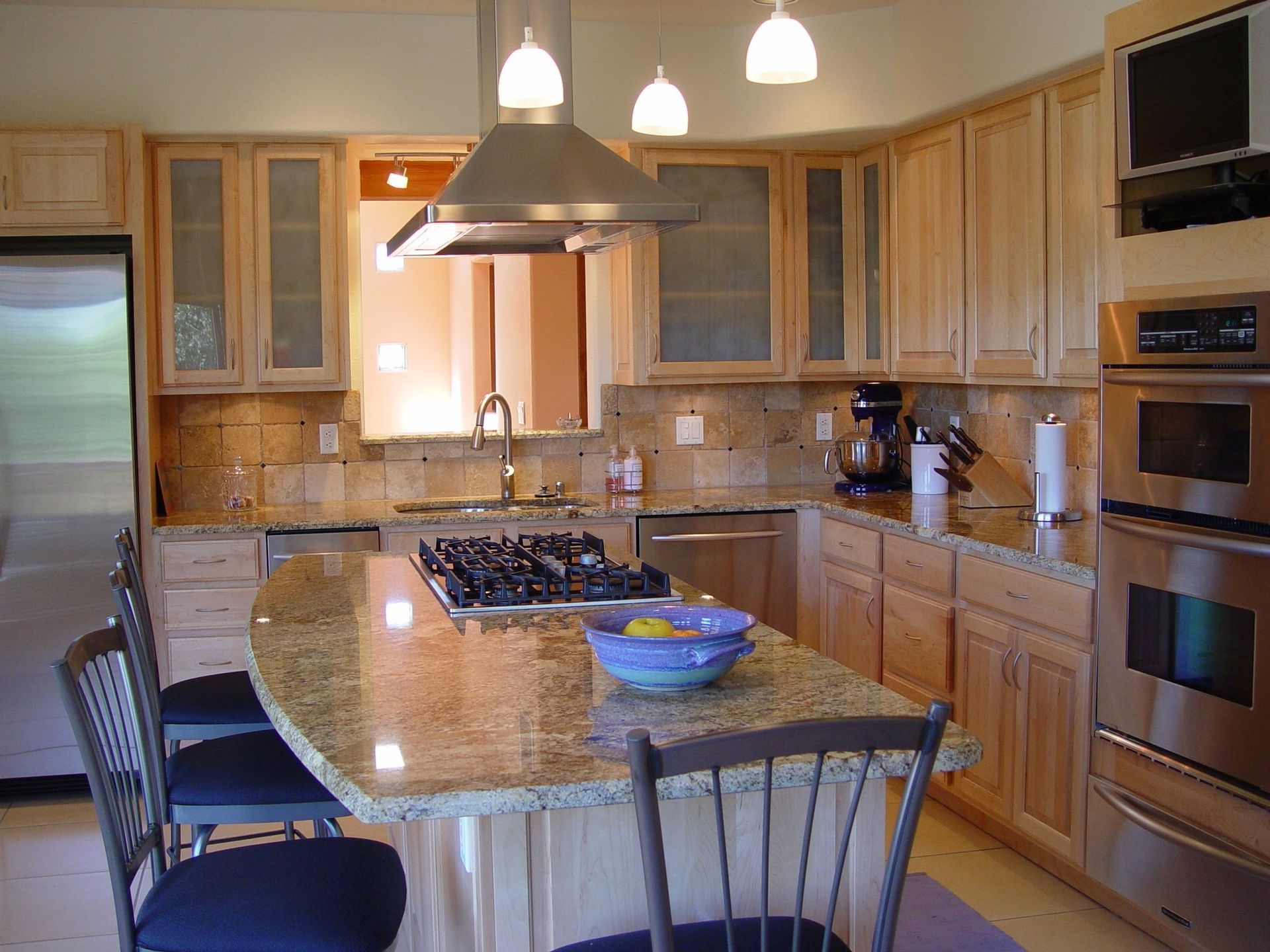 A kitchen with stainless steel appliances and granite counter tops
