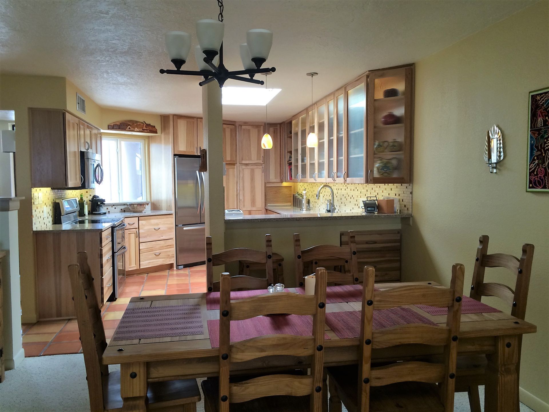 A kitchen and dining room with a table and chairs