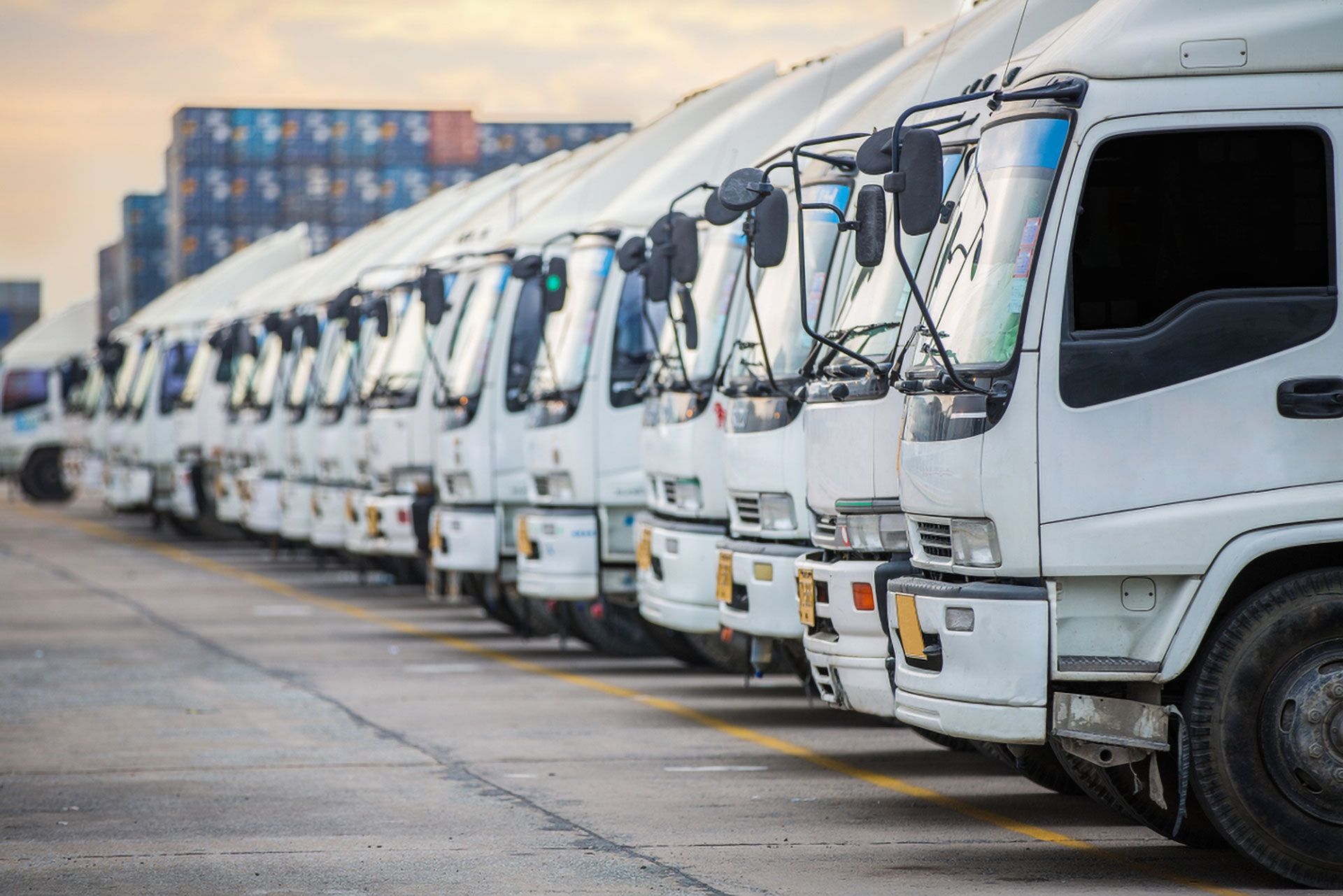 Row of White Delivery Trucks Parked in a Lot, Viewed From the Front at an Angle — Forster Smash Repairs in Forster, NSW