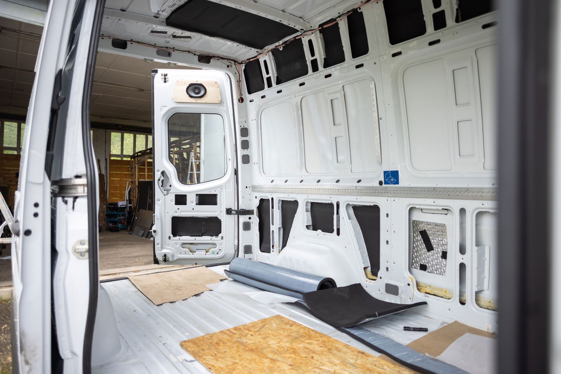 Inside an Empty White Cargo Van With Exposed Interior Panels — Forster Smash Repairs in Forster, NSW