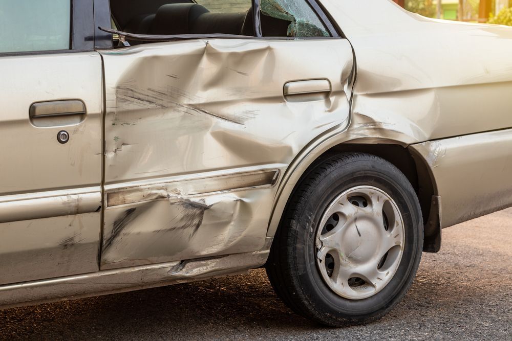 Damaged Beige Car Door and Rear Side Panel With a Large Dent and Crumpled Metal — Forster Smash Repairs in Forster, NSW