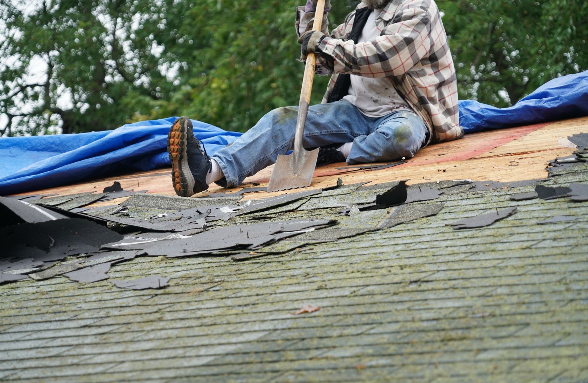 Expert roofer working on repairing the roof. Expert roofer working on repairing the roof.