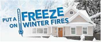 Sign promoting winter fire safety. Text reads: Put a freeze on winter fires with a thermometer graphic and a snowy house.