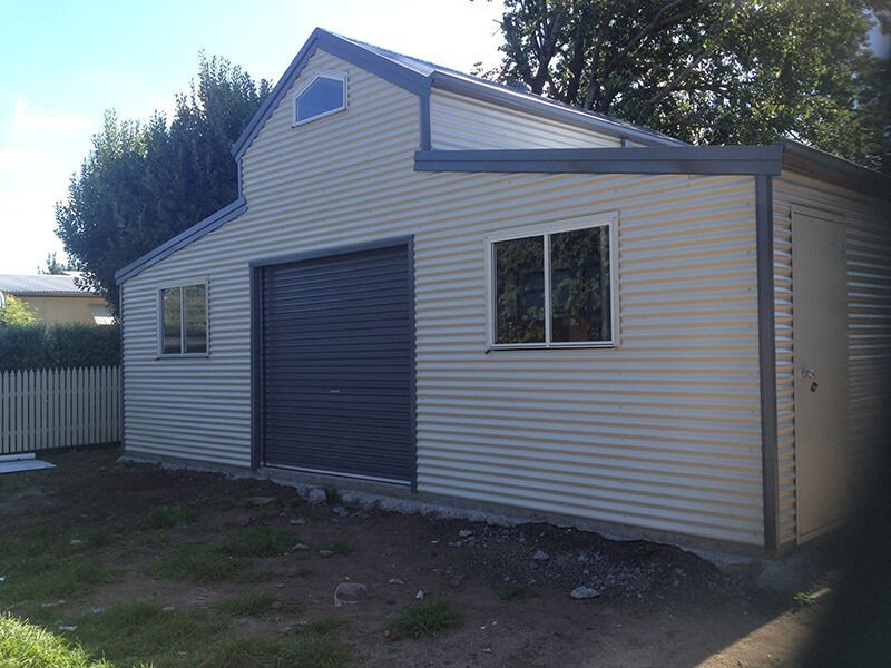 A White Garage with a Black Garage Door - Wallan, VIC - Victorian Garages & Barns