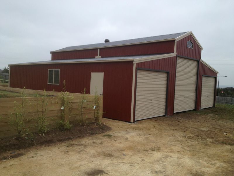 A Red and White Barn with Two Garage Doors - Wallan, VIC - Victorian Garages & Barns