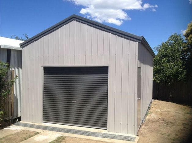 A Garage with a Gray Garage Door is in the House - Wallan, VIC - Victorian Garages & Barns