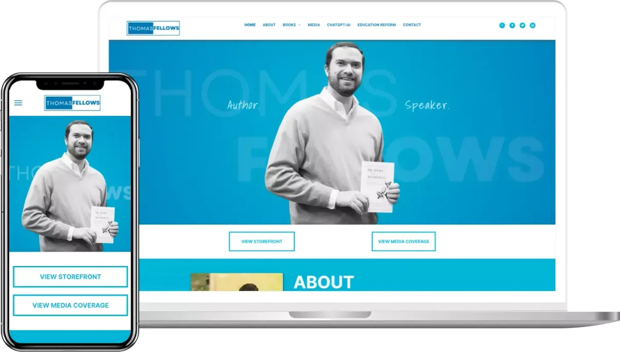 A man is holding a book in front of a laptop and a cell phone.