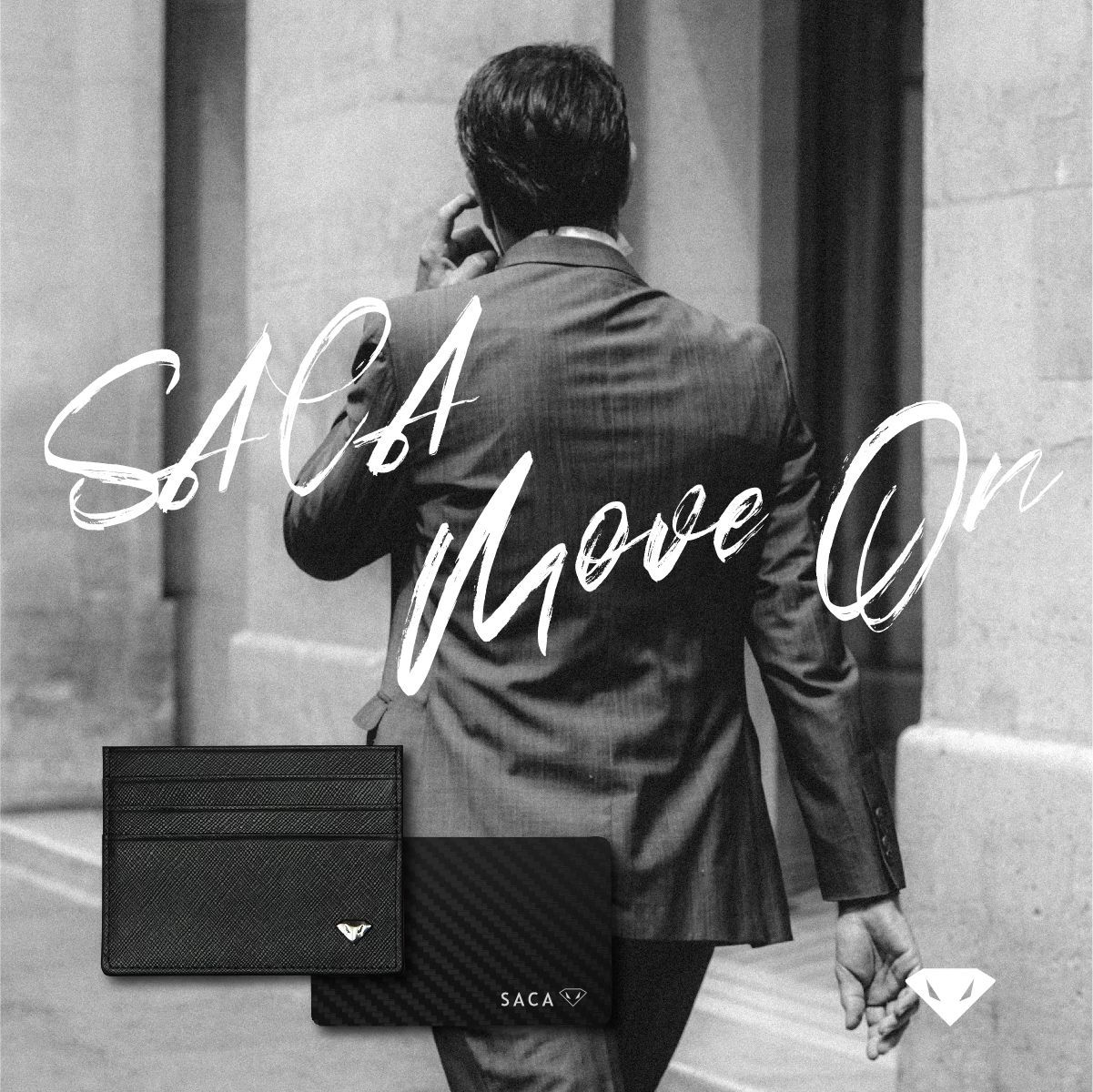 The back of a man in a dark suit walking away, in black and white