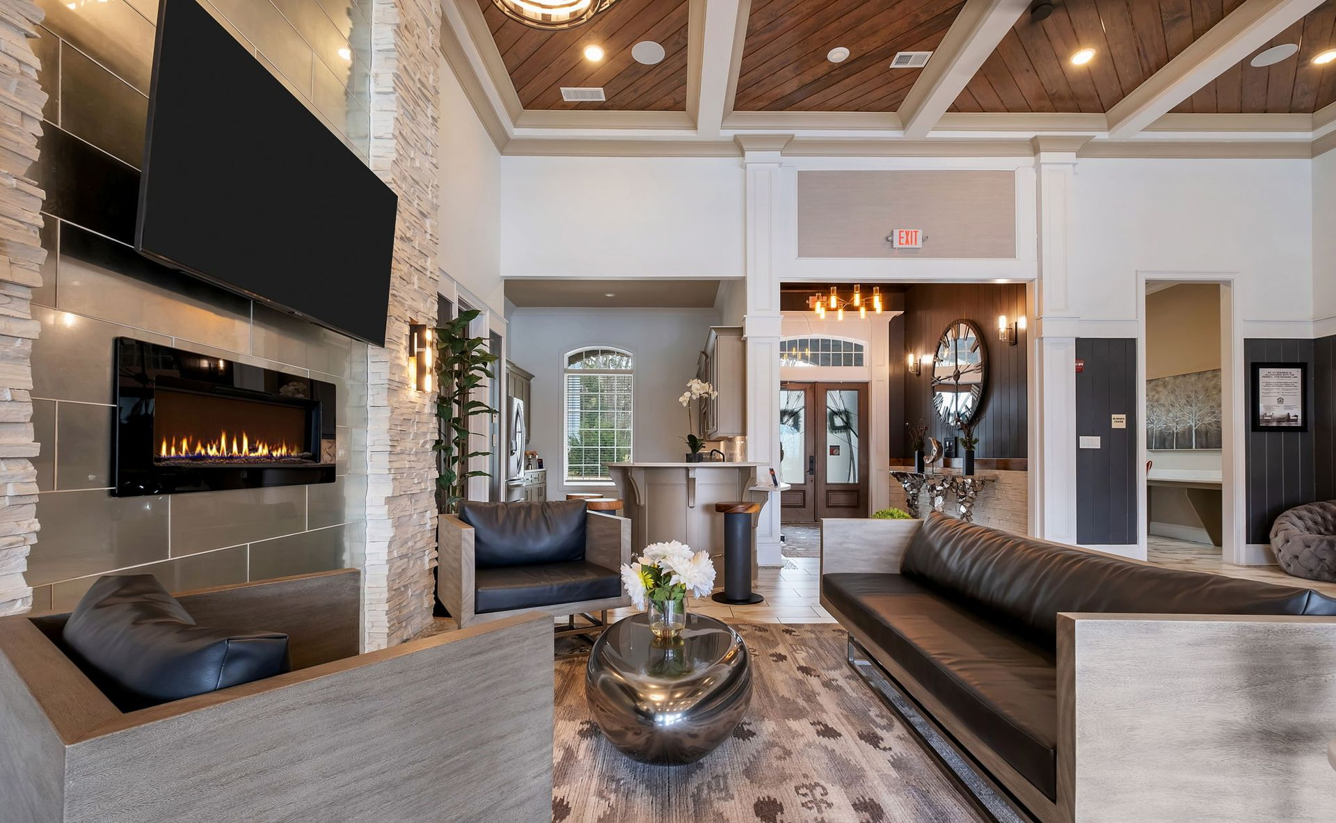 Modern community lounge area with flat screen TV, fireplace and comfortable seating perfect for congregating.