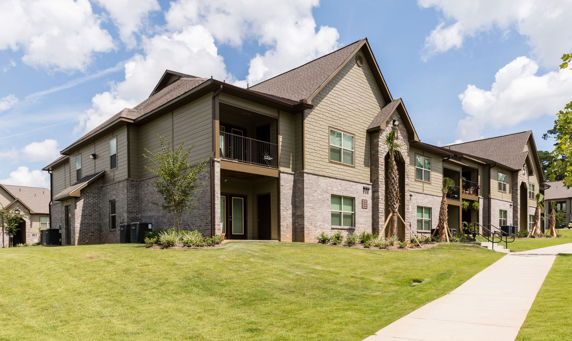 Exterior view of a residential community with lush green landscaping.