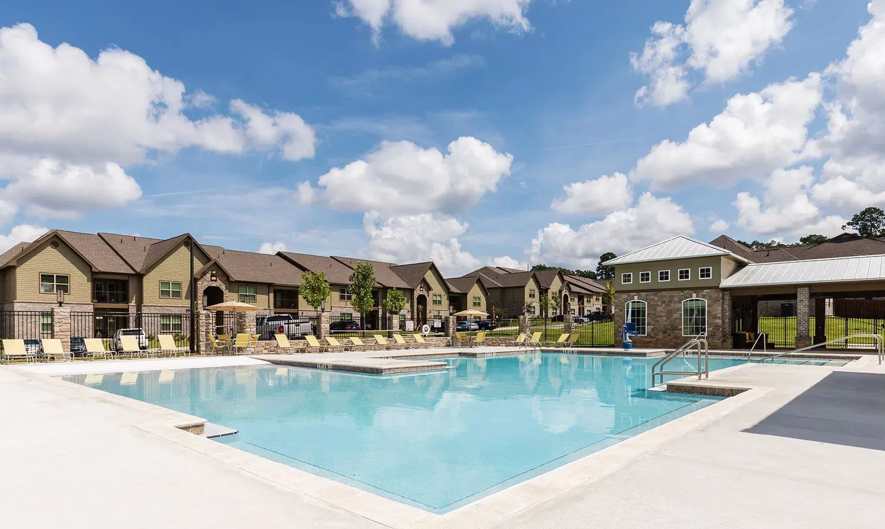 Large swimming pool and lounge chairs at Grove Park apartments.