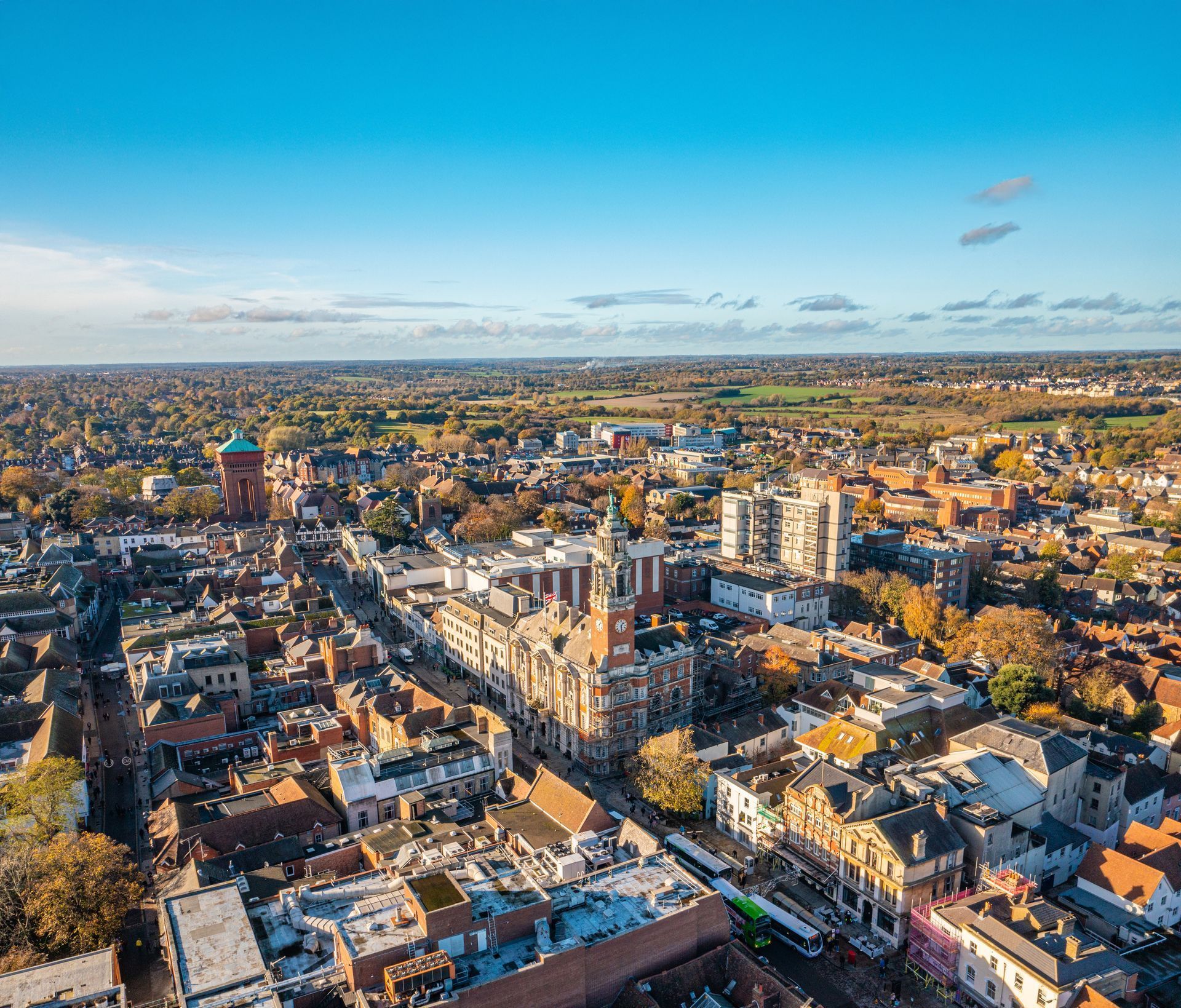 Aerial view of a dense cityscape with a large historic church and blue sky