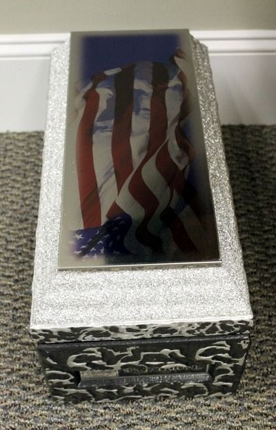 A granite memorial with an American flag graphic.