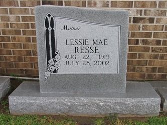 Gray headstone of Lessie Mae Resse, with dates 1919-2002, against a brick wall.