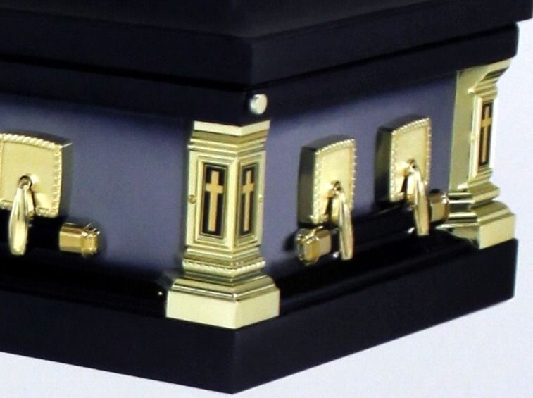 Black casket with gold accents.