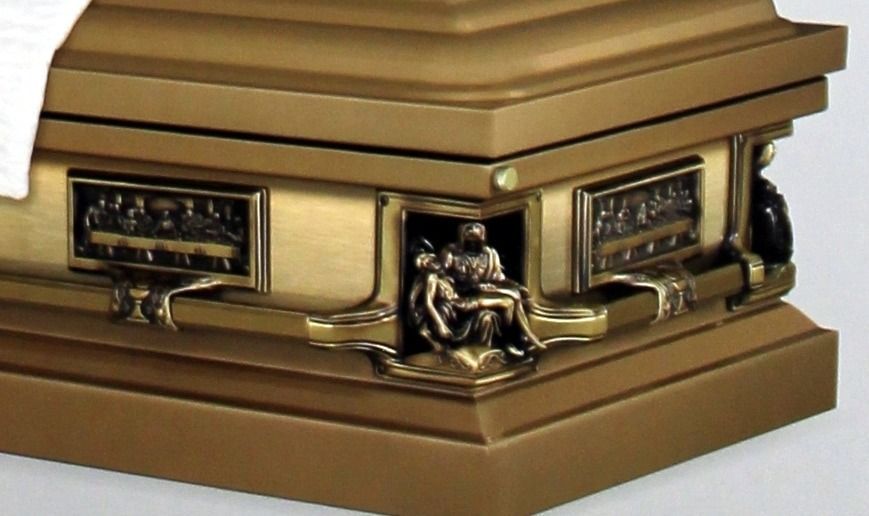 Bronze casket with religious relief carvings and intricate metalwork.