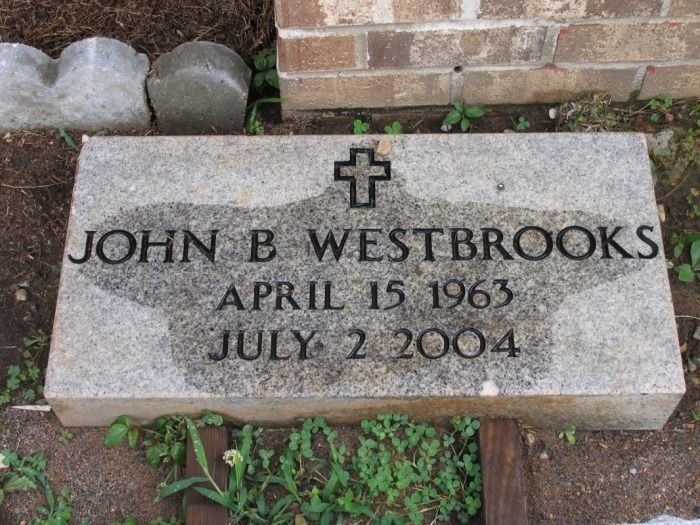 Tombstone for John B. Westbrooks, born April 15, 1963, died July 2, 2004, with a cross.
