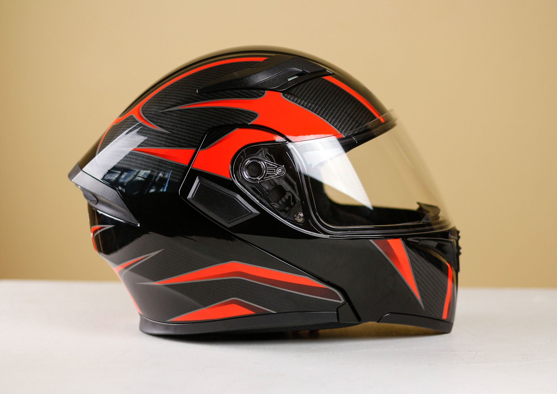 A black and red motorcycle helmet with a clear visor