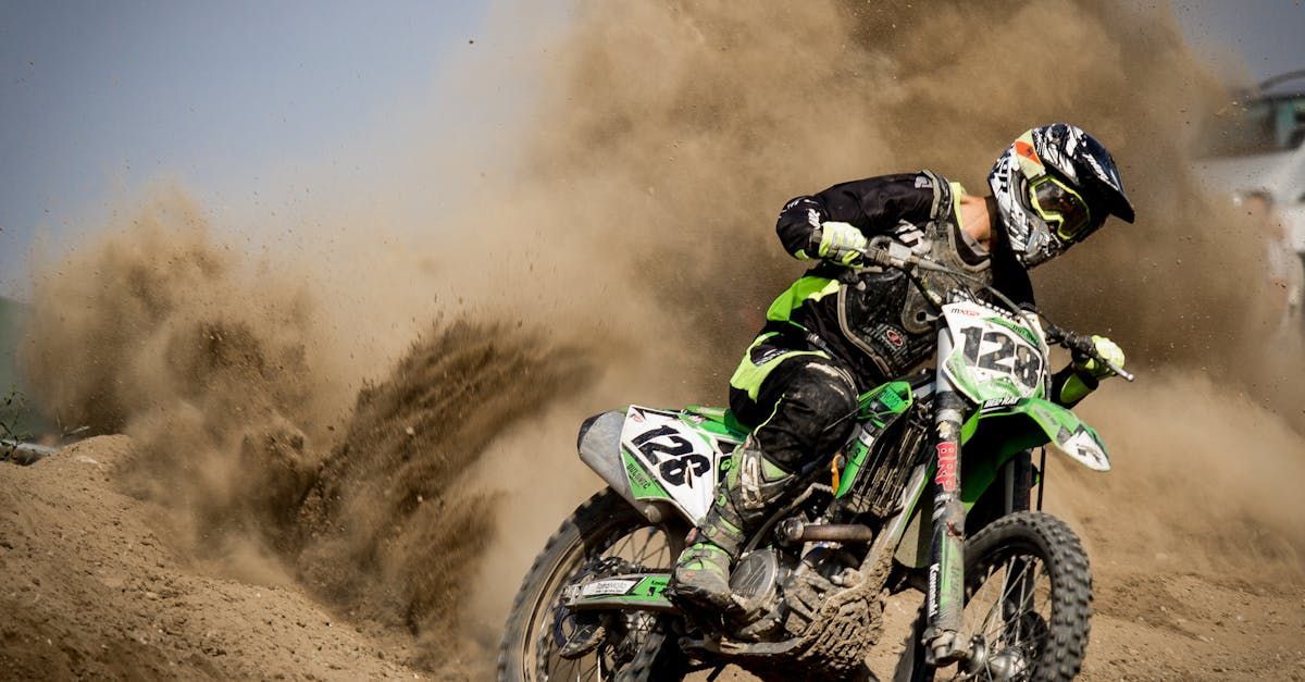 A person is riding a dirt bike on a dirt track.